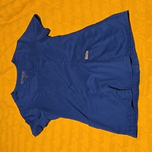 Blue scrub top, small hole on arm